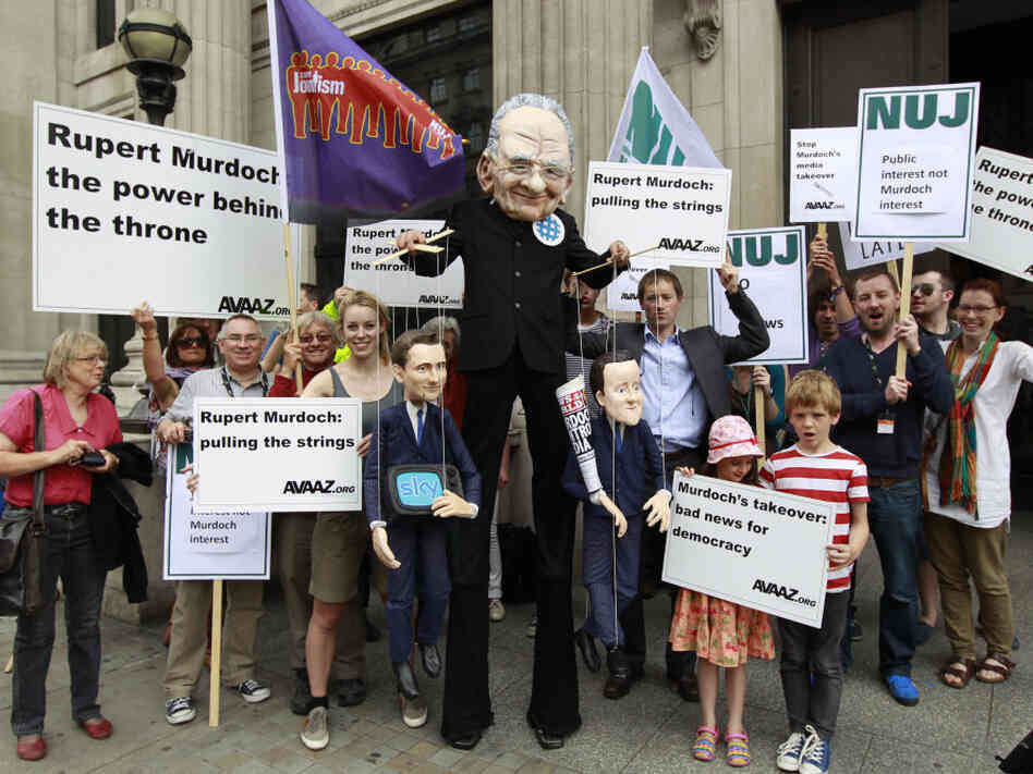 Demonstrators, one wearing a mask depicting Rupert Murdoch (center), holds puppets depicting British Prime Minister David Cameron (right) and British Culture Minister Jeremy Hunt (left) as they protest outside the Department of Culture Media and Sport in central London on Thursday to show their opposition to the proposed sale of BSkyB to Murdoch's News International. Demonstrators, one wearing a mask depicting Rupert Murdoch (center), holds puppets depicting British Prime Minister David Cameron (right) and British Culture Minister Jeremy Hunt (left) as they protest outside the Department of Culture Media and Sport in central London on Thursday to show their opposition to the proposed sale of BSkyB to Murdoch's News International.