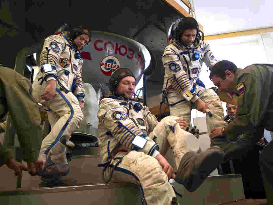 Crew members of the International Space Station — (from left) U.S. astronaut Ron Garan and Russian cosmonauts Alexander Samokutyaev and Andrei Borisenko — prepare to enter a Soyuz simulator outside Moscow on March 30. With the space shuttle program out of commission, the Russian Soyuz vehicle will be the only way for Americans to reach space.