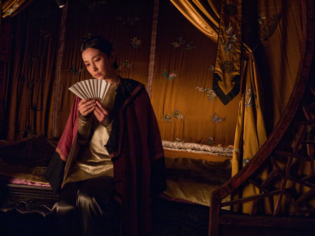 The characters Lily (shown) and Snow Flower exchange secret messages written between the folds of a fan.