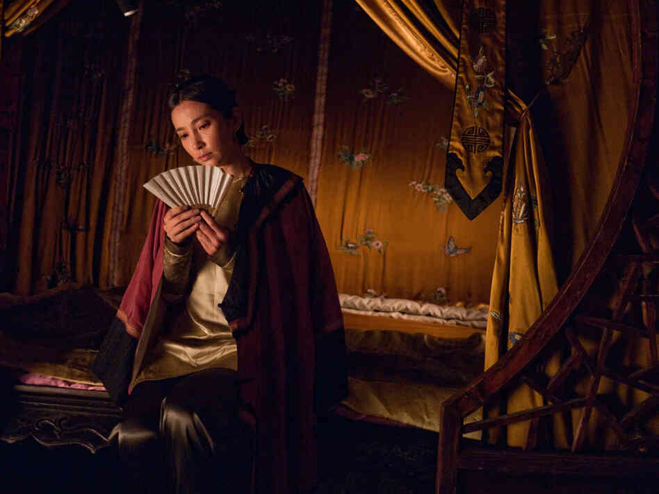 The characters Lily (shown) and Snow Flower exchange secret messages written between the folds of a fan.