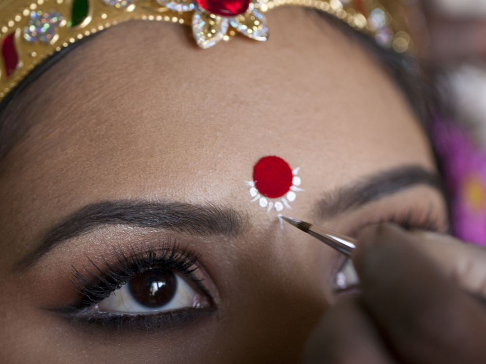 A make-up artist studied and painted the features of Maa  Laxmi's eyes and ornamental touches.