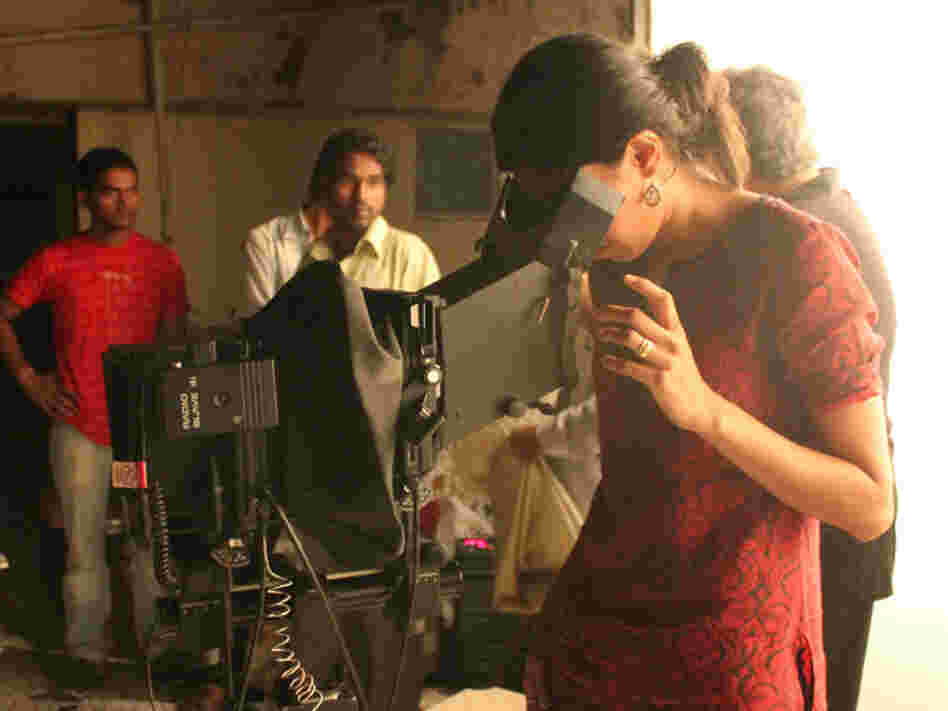 Sharma peers through her large-format camera on set.