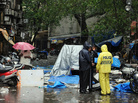 Policemen stand at the blast site at Opera House in Mumbai on July 14, 2011, one of three that killed at least 17 people. Policemen stand at the blast site at Opera House in Mumbai on July 14, 2011, one of three that killed at least 17 people.