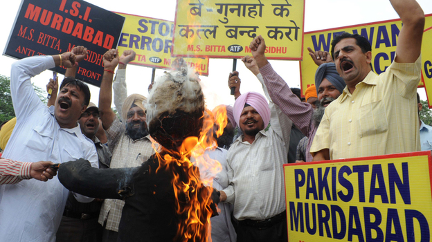 Members of the All India Anti-Terrorist Front burn an effigy of a terrorist and shout slogans condemning the triple bomb blasts in Mumbai during a demonstration in Amritsar, India, on Thursday. Members of the All India Anti-Terrorist Front burn an effigy of a terrorist and shout slogans condemning the triple bomb blasts in Mumbai during a demonstration in Amritsar, India, on Thursday.