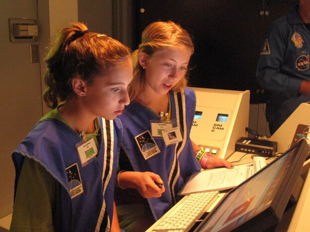 Seventh-graders Sophie  Maloro (left) and Unity Bowling "fly" a mission to Mars, part of a summer program at the MathScience  Innovation Center in Richmond, Va.