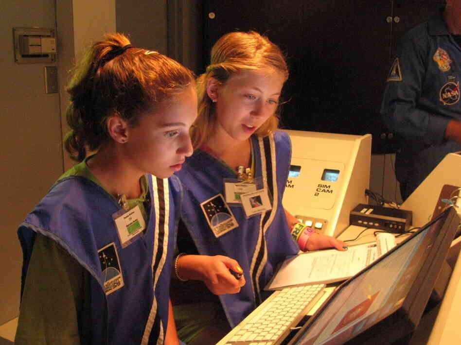 Seventh-graders Sophie  Maloro (left) and Unity Bowling "fly" a mission to Mars, part of a summer program at the MathScience  Innovation Center in Richmond, Va.