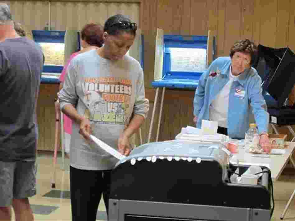 A voter casts a ballot in a Democratic primary on July 12 in Wisconsin, one of seven states to enact voter ID laws this year. A voter casts a ballot in a Democratic primary on July 12 in Wisconsin, one of seven states to enact voter ID laws this year.