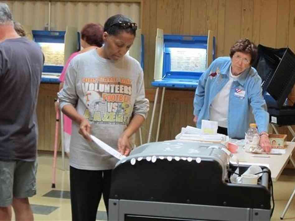A voter casts a ballot in a Democratic primary on July 12 in Wisconsin, one of seven states to enact voter ID laws this year. A voter casts a ballot in a Democratic primary on July 12 in Wisconsin, one of seven states to enact voter ID laws this year.