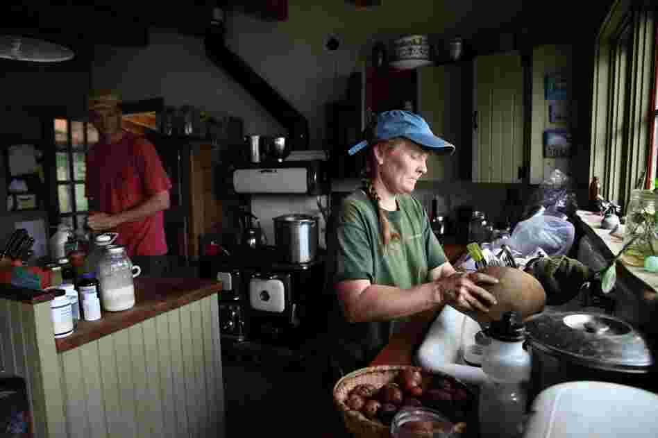 Penny Hewitt prepares lunch of potatoes and green beans picked from the family garden. The Hewitts estimate they grow and raise 80 percent of their own food.