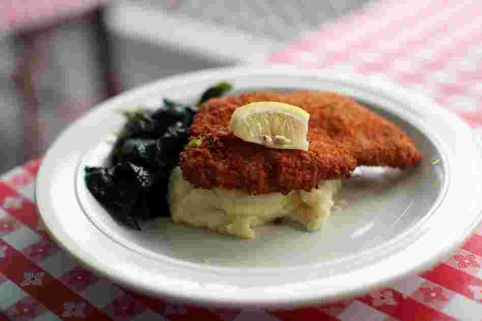 Schnitzel over mashed potatoes is served with a side of Pete's Greens kale at the Highland Lodge in nearby Greensboro, Vt.