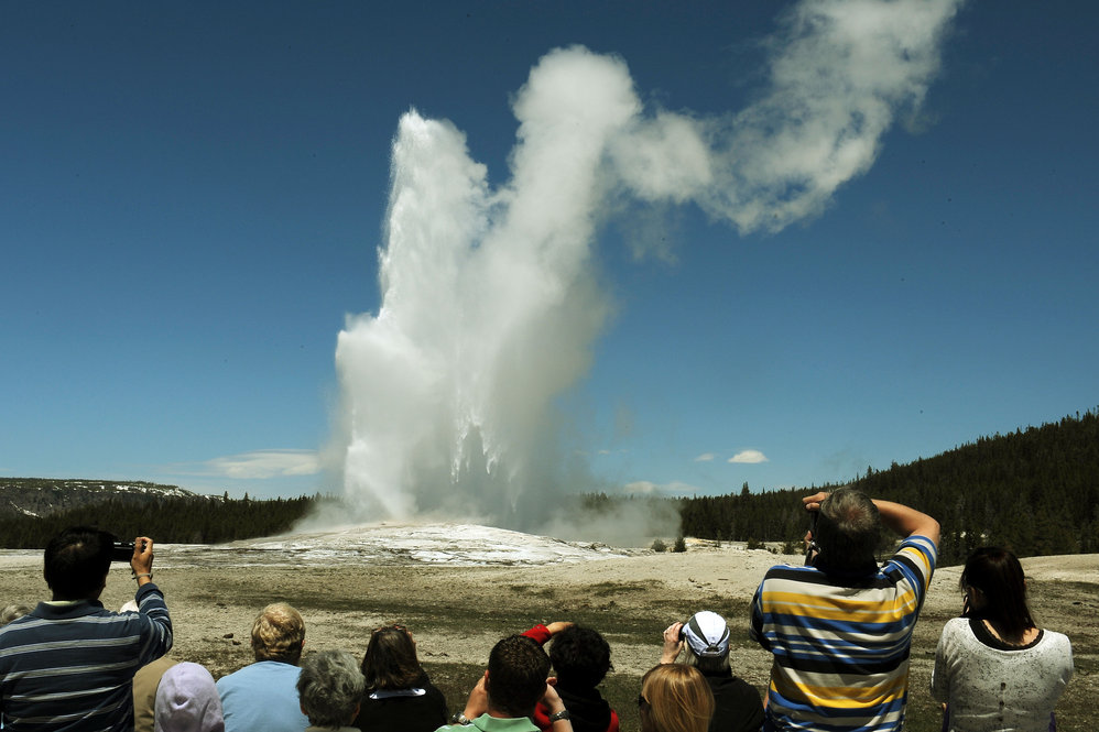 Tourists watch the Old Faithful geyser, which erupts on average every 90 minutes.
