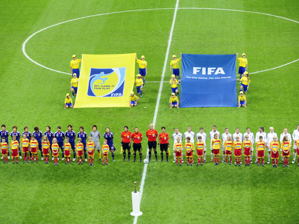 Players of the USA (R) and Japan stand in a line prior to the FIFA Women's Football World Cup final match of Japan vs USA on July 17, 2011 in Frankfurt/M., western Germany.