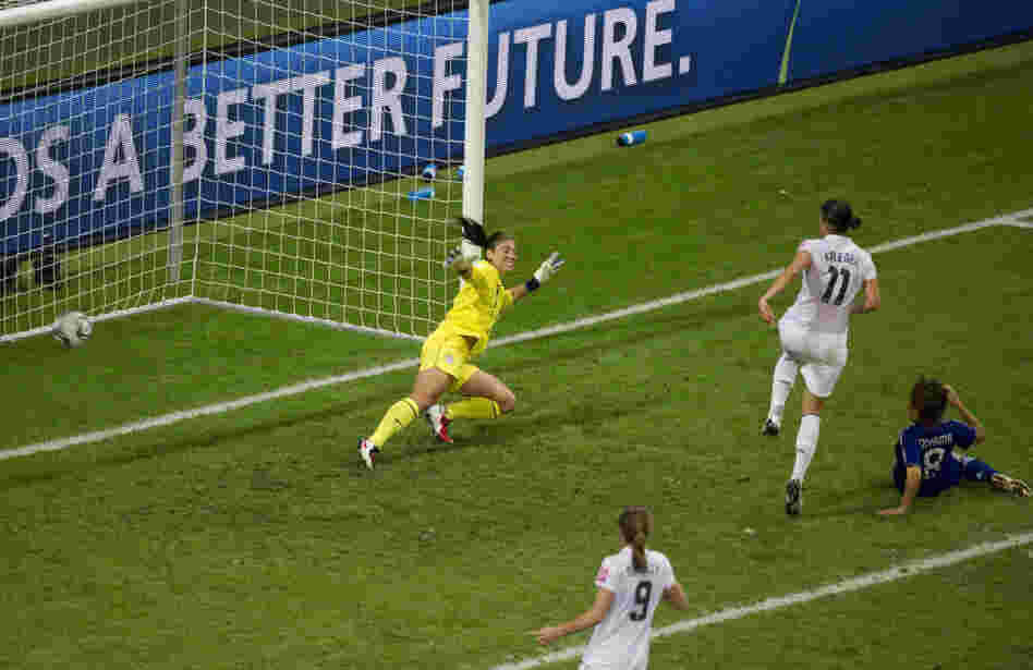 Japan's Aya Miyama scores her country's first goal of the Women's World Cup title match, getting the ball past U.S. goalkeeper Hope Solo. Japan won 3-1 in a penalty shoot-out after overtime expired with the two teams tied, 2-2. Japan became the first Asian nation to win the World Cup.