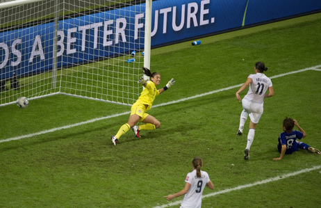 Japan's Aya Miyama scores her country's first goal of the Women's World Cup title match, getting the ball past U.S. goalkeeper Hope Solo. Japan won 3-1 in a penalty shoot-out after overtime expired with the two teams tied, 2-2. Japan became the first Asian nation to win the World Cup.