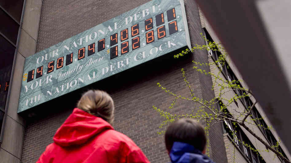 Pedestrians stop to view the National Debt Clock in New York this April. The debt ceiling is becoming an election issue, as groups on both sides spend millions on TV ads. Pedestrians stop to view the National Debt Clock in New York this April. The debt ceiling is becoming an election issue, as groups on both sides spend millions on TV ads.