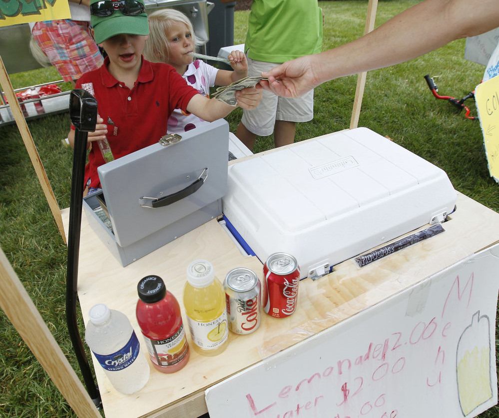 Young entrepreneurs collect money at their lemonade stand outside the site of the U.S. Open Championship golf tournament in June in Montgomery County, Md.