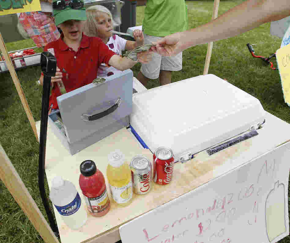 Young entrepreneurs collect money at their lemonade stand outside the site of the U.S. Open Championship golf tournament in June in Montgomery County, Md.