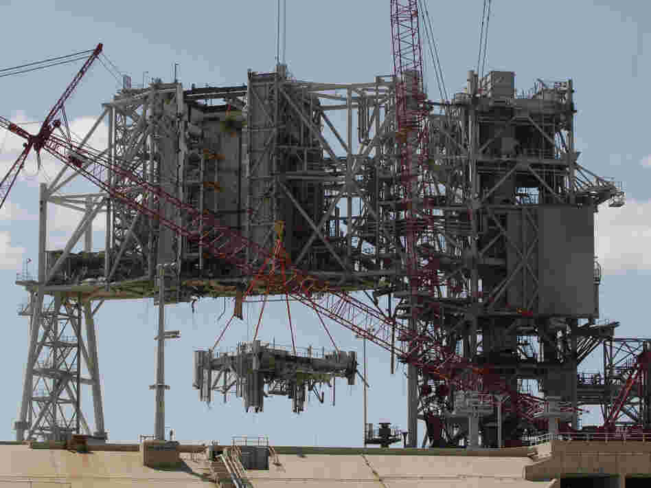 Cranes deconstruct a large section of the structure used to launch the space shuttles at launchpad 39B at Kennedy Space Center on April 6.