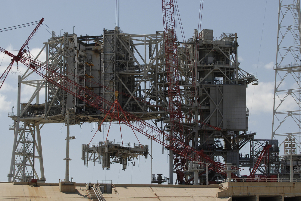 Cranes deconstruct a large section of the structure used to launch the space shuttles at launchpad 39B at Kennedy Space Center on April 6.