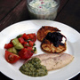 Traditional Soviet summer fare: a bowl of Okroshka (Cold Kefir Soup), Syrniki (Curd-Cheese Pancakes) with berries and sour cream, Grilled Trout with Tarragon and Cilantro Walnut Sauce, and Azerbaijan Salad.