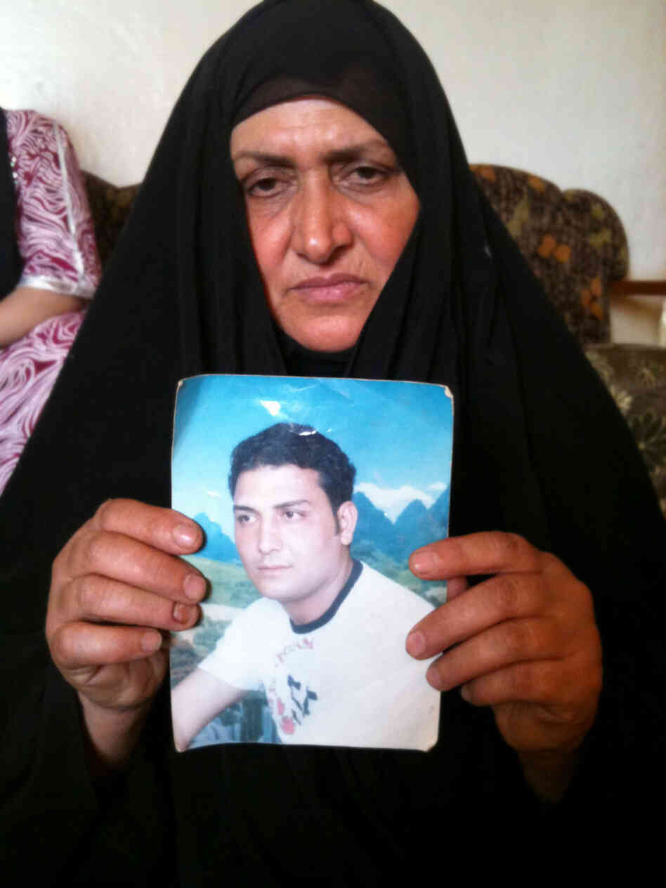Umm Haidar holds a photograph of her missing son, Haidar. Umm Haidar holds a photograph of her missing son, Haidar.