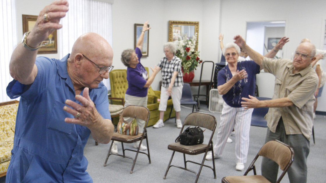 Volunteer John Kelley (left) leads an exercise class at a senior center in Oklahoma on Monday. Centers such as these offer seniors a cool place to go during heat waves.