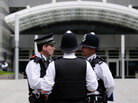 Police officers stand outside the News International offices in east London on July 10, 2011, as police inquiries continue into the News of the World phone hacking scandal. In the second hour, guests talk about the often complicated relationship between police and reporters. Police officers stand outside the News International offices in east London on July 10, 2011, as police inquiries continue into the News of the World phone hacking scandal. In the second hour, guests talk about the often complicated relationship between police and reporters.