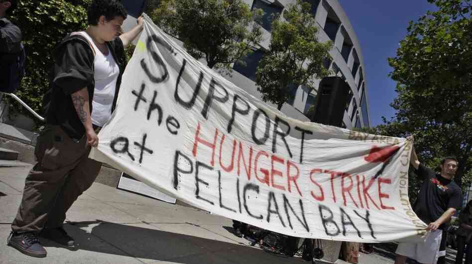 Demonstrators hold up a sign during a rally in front of the State Building in San Francisco on July 1 to support prisoners at Pelican Bay State Prison. Inmates in an isolation unit at the prison went on a hunger strike to protest conditions they describe as inhumane. The hunger strike later spread to other facilities. Demonstrators hold up a sign during a rally in front of the State Building in San Francisco on July 1 to support prisoners at Pelican Bay State Prison. Inmates in an isolation unit at the prison went on a hunger strike to protest conditions they describe as inhumane. The hunger strike later spread to other facilities.