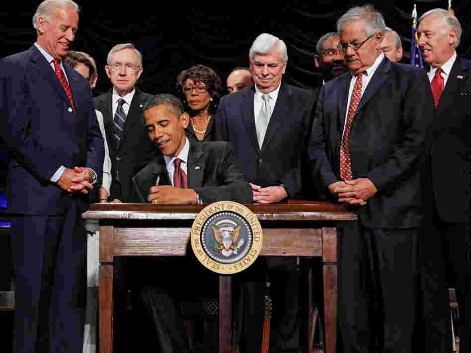 President Obama signs the financial reform bill into law, July 21, 2010. Vice President Joe Biden, Senate Majority Leader Harry Reid (D-NV), then Senate Banking Chairman Christopher Dodd (D-CT), House Financial Services Committee Chairman Barney Frank (D-MA) and other lawmakers look on.