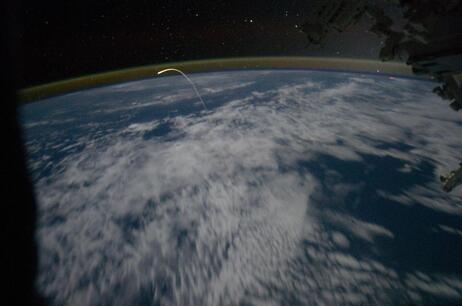 This unprecedented view of the space shuttle Atlantis, appearing like a bean sprout against clouds and city lights, on its way home, was photographed by the Expedition 28 crew of the International Space Station. Airglow over Earth can be seen in the background. This unprecedented view of the space shuttle Atlantis, appearing like a bean sprout against clouds and city lights, on its way home, was photographed by the Expedition 28 crew of the International Space Station. Airglow over Earth can be seen in the background.