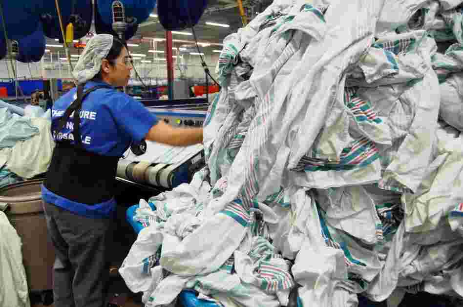 Maria Murillo processes clean baby blankets at Healthcare Laundry Systems in Wheeling, Ill. Last year, the laundry purchased 180,000 blankets to supply to hospitals around Chicago. Each blanket lasts approximately 15 washes before it's thrown out or lost.