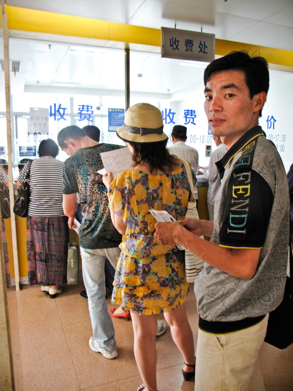 Queuer Li Qicai waits in line at a  Shanghai hospital to collect traditional Chinese  medicine for a customer. He says he does a dozen hospital jobs a  week.