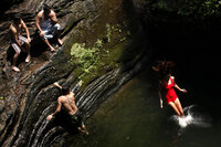 Bathers beat the midday heat at the Devil's Pool in Wissahickon Valley Park on Wednesday in Philadelphia.