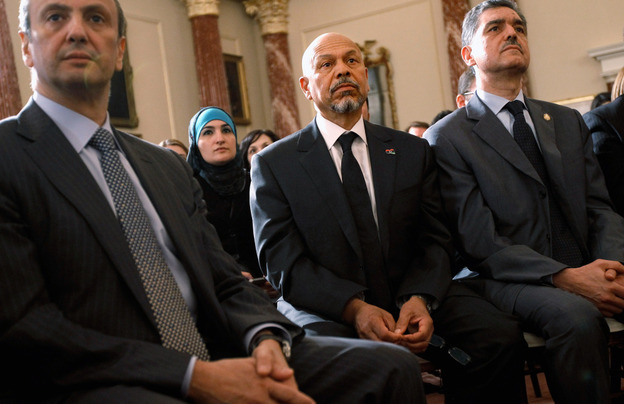 Ali Aujali (second from right) listens to President Obama speak at the State Department in May. Aujali was Moammar Gadhafi's ambassador to the U.S., but resigned after the Libyan uprising began. He now represents the rebels' Transitional National Council. Ali Aujali (second from right) listens to President Obama speak at the State Department in May. Aujali was Moammar Gadhafi's ambassador to the U.S., but resigned after the Libyan uprising began. He now represents the rebels' Transitional National Council.