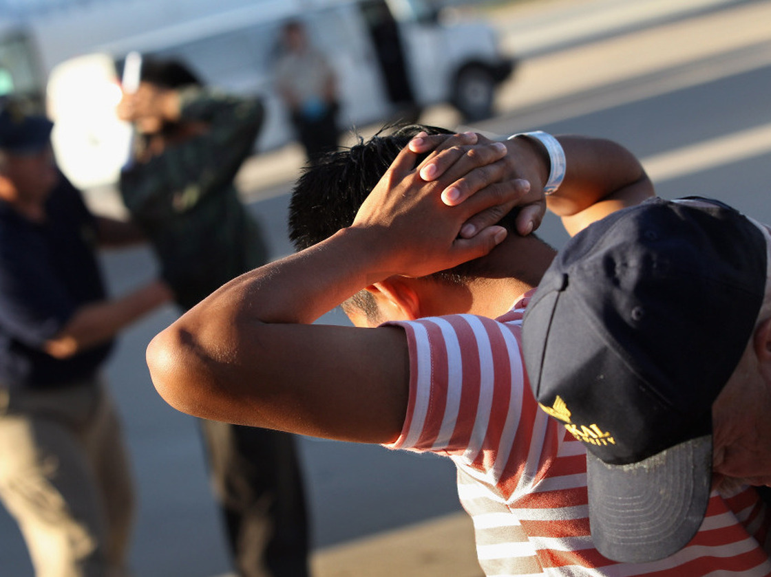 Illegal immigrants from Guatemala are body searched before boarding a deportation flight on June 24, 2011 in Mesa, Arizona. Each month the U.S. Immigration and Customs Enforcement agency sends thousands of undocumented immigrants back to Guatemala. Many have been caught by in the Secure Communities data-sharing program.