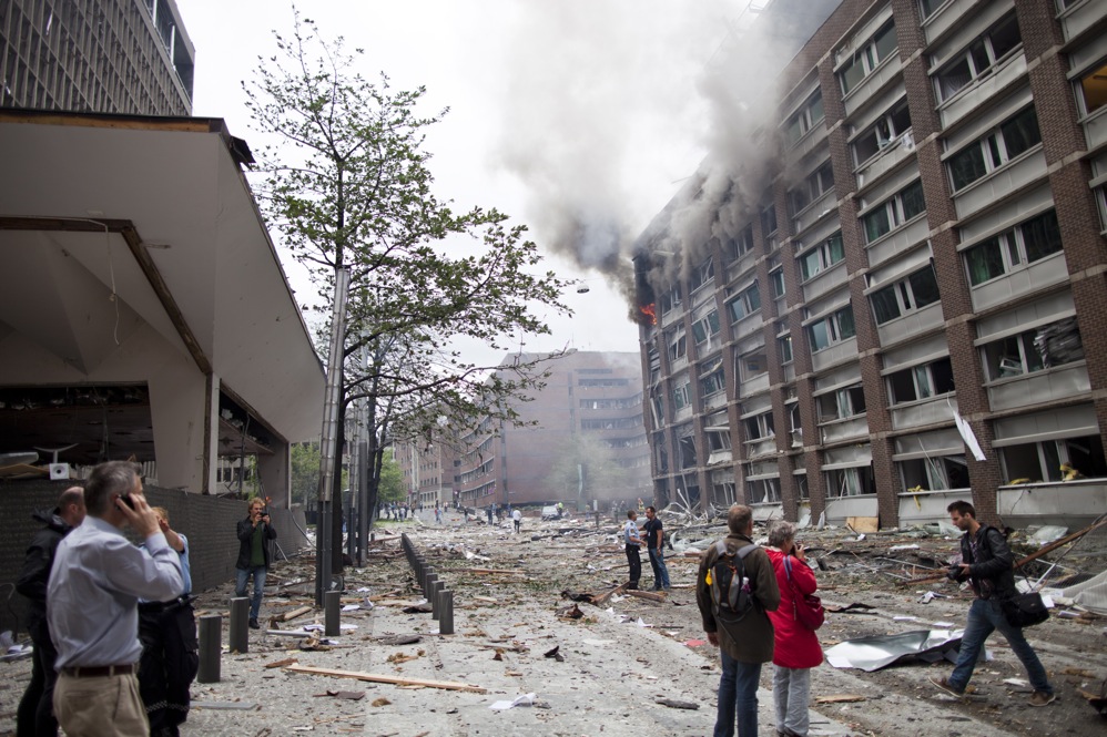 Debris covers the street outside buildings in the center of Oslo following Friday's explosion, which tore open several government buildings, including the prime minister's office. 
