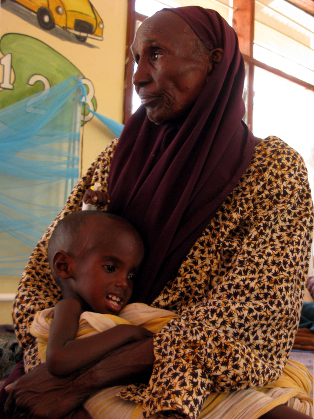 Hawa Hassan cradles her grandson, Adan Abdon, 3, who is suffering from malnutrition. Adan's mother died during the 30-day walk from southern Somalia to Kenya.