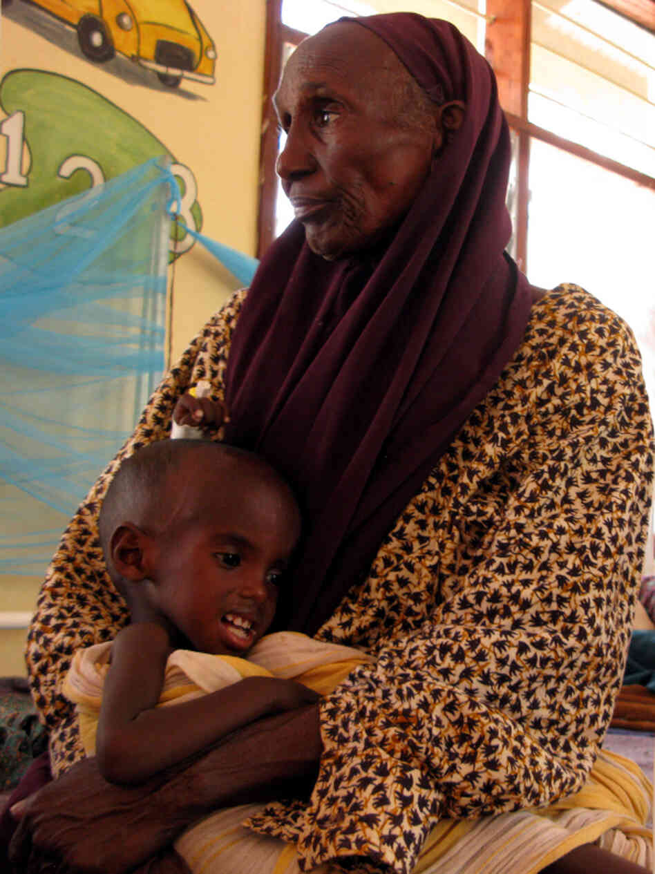 Hawa Hassan cradles her grandson, Adan Abdon, 3, who is suffering from malnutrition. Adan's mother died during the 30-day walk from southern Somalia to Kenya.