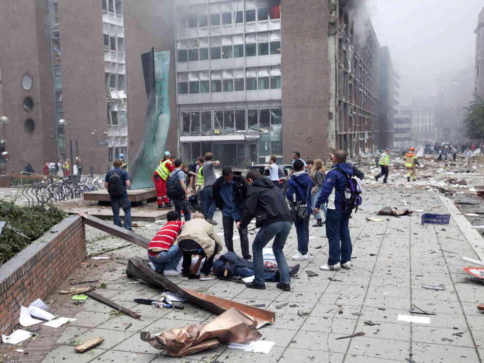 Injured people lay on the ground at the site of an explosion near the government buildings in Norway's capital Oslo earlier today (July 22, 2011).