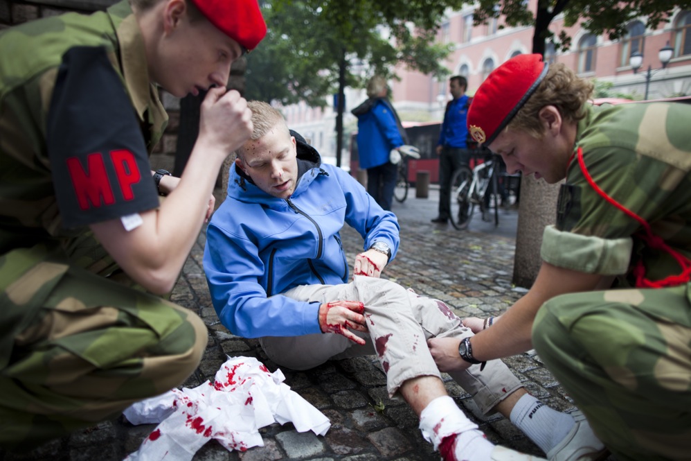 An injured man is treated at the scene. 
