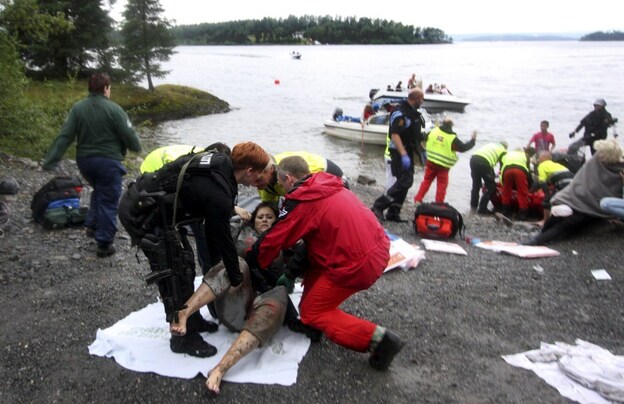 A wounded woman is brought ashore from Norway's Utoya Island after being rescued from a gunman who went on a killing rampage at a summer youth camp southwest of Oslo Friday. A wounded woman is brought ashore from Norway's Utoya Island after being rescued from a gunman who went on a killing rampage at a summer youth camp southwest of Oslo Friday.