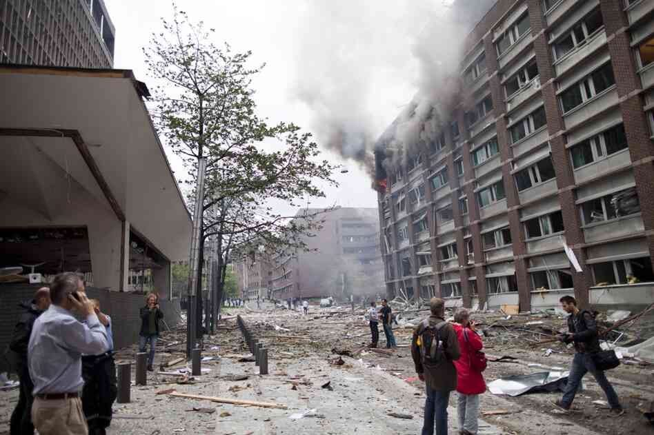 Debris covers the street outside buildings in the center of Oslo following Friday's explosion, which tore open several government buildings, including the prime minister's office. 