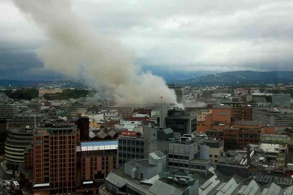 Smoke rises from the city center following the explosion. 