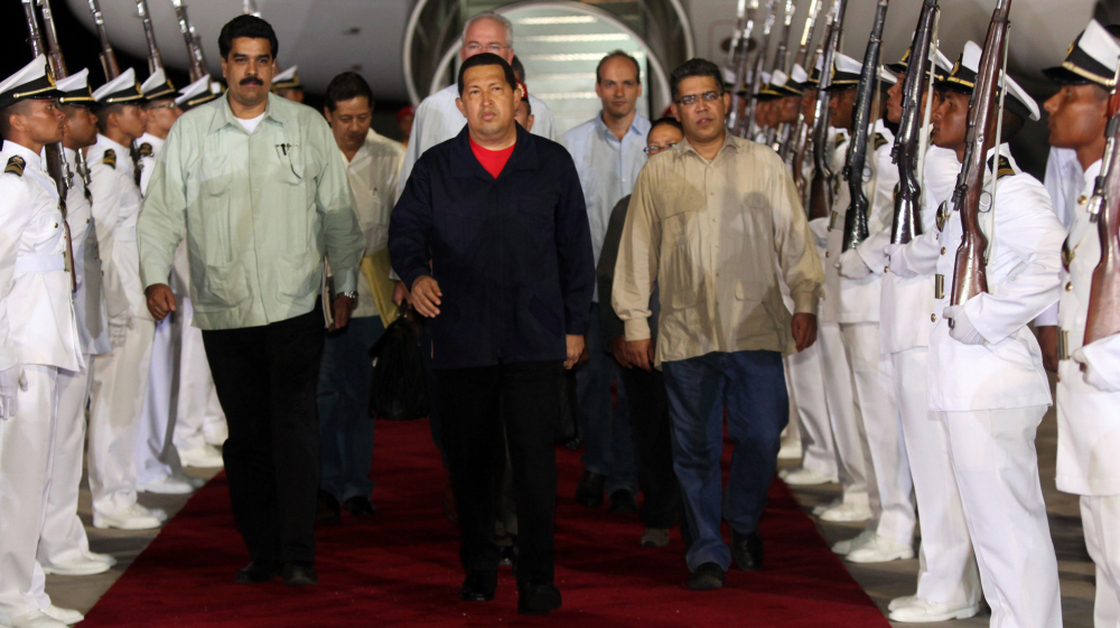 Venezuelan President Hugo Chavez (wearing red) arrives in Caracas from Cuba on July 23, 2011.