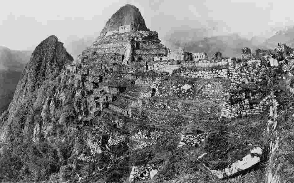 The Incan ruins of Machu Picchu are situated near Cuzco in Peru. They escaped the attention of the Spaniards and were not "discovered" until 1911 by U.S. explorer Hiram Bingham. Photographed here is Intihuatana Hill and the terraces west of the Sacred Plaza..