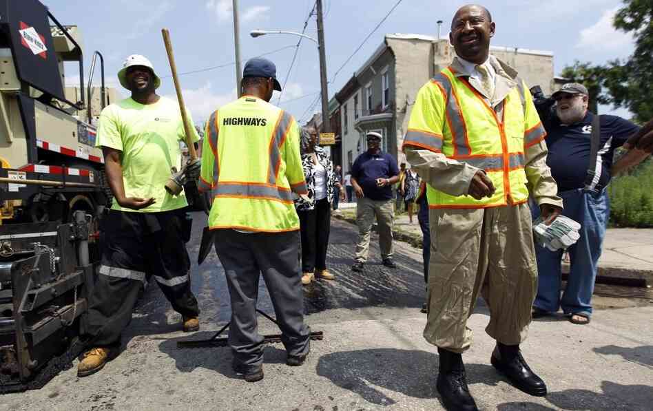 Philadelphia Mayor Michael Nutter (right) joins workers to draw attention to the city's streets repaving project July 18. Philadelphia Mayor Michael Nutter (right) joins workers to draw attention to the city's streets repaving project July 18.