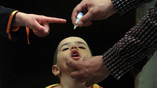 An Afghan health worker administers the polio vaccine to a child during a vaccination campaign in Kabul, Afghanistan, in 2010.