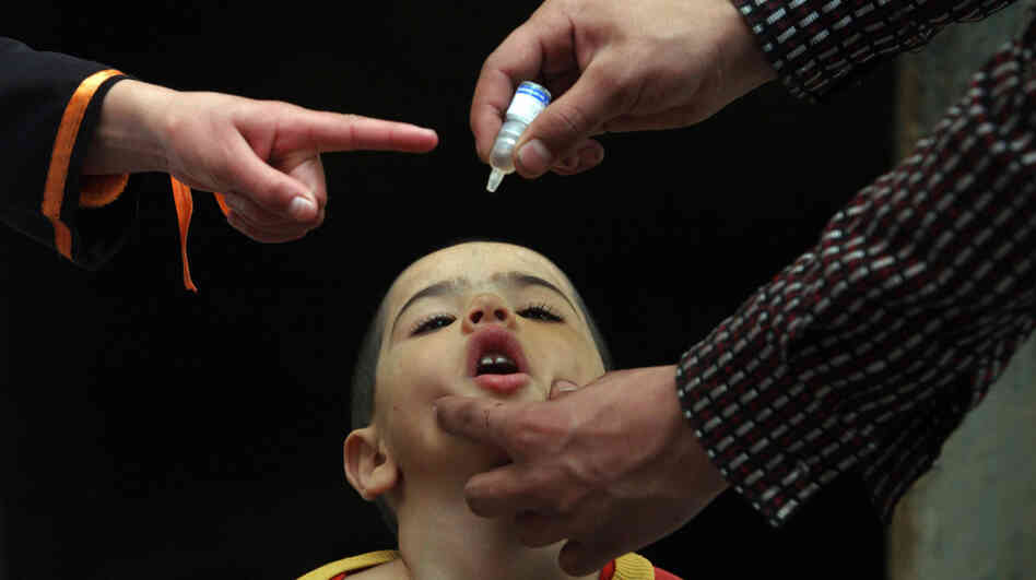 An Afghan health worker administers the polio vaccine to a child during a vaccination campaign in Kabul, Afghanistan, in 2010.