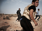 Libyan rebel fighters run for cover at the front line near the southwest desert town of Gualish on July 24, as Gadhafi forces started attacking them in an attempt to capture the city. Libyan rebel fighters run for cover at the front line near the southwest desert town of Gualish on July 24, as Gadhafi forces started attacking them in an attempt to capture the city.