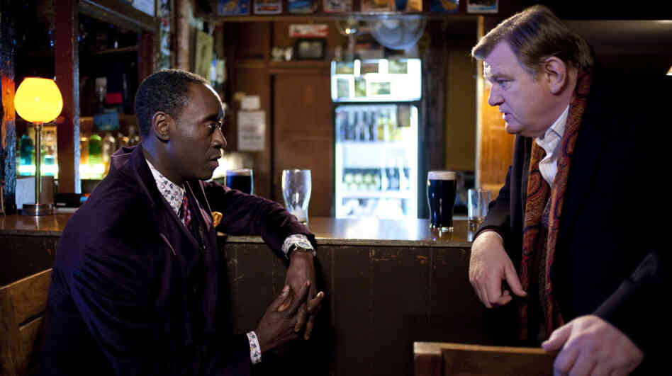 Cop And A Laugh: Sgt. Gerry Boyle (Brendan Gleeson, right) finds his routine indulgences challenged by the presence of straight-laced FBI Agent Wendell Everett (Don Cheadle) in his small Irish patrol. The pair must work together to track down a trio of dope smugglers. Cop And A Laugh: Sgt. Gerry Boyle (Brendan Gleeson, right) finds his routine indulgences challenged by the presence of straight-laced FBI Agent Wendell Everett (Don Cheadle) in his small Irish patrol. The pair must work together to track down a trio of dope smugglers.